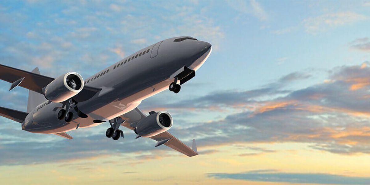 Airplane shortly after takeoff flying at sunset