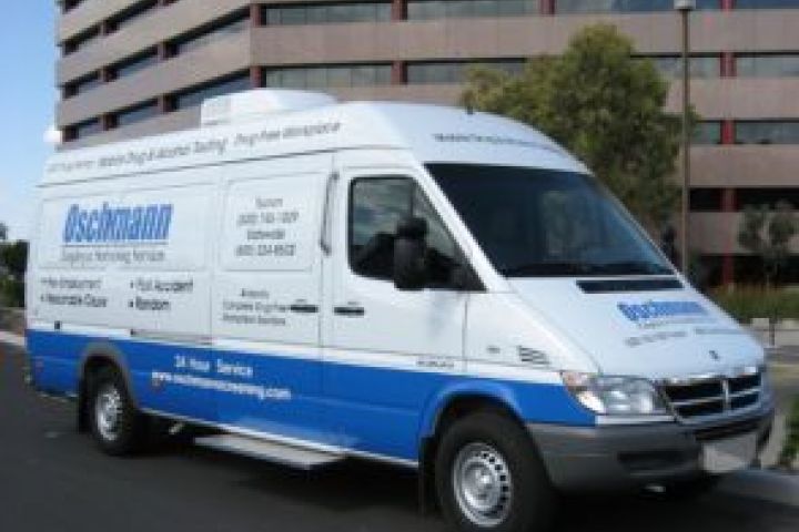 A white onsite testing van with blue lettering