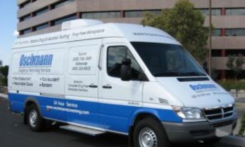 A white onsite testing van with blue lettering