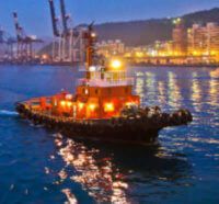 A tug boat on a river through a city