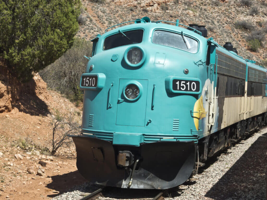 A large train travelling through hills in Southern Arizona