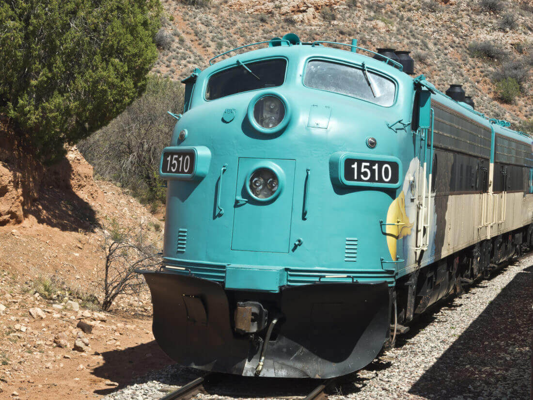 A large train travelling through hills in Southern Arizona