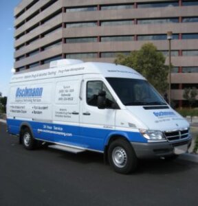 A white onsite testing van with blue lettering