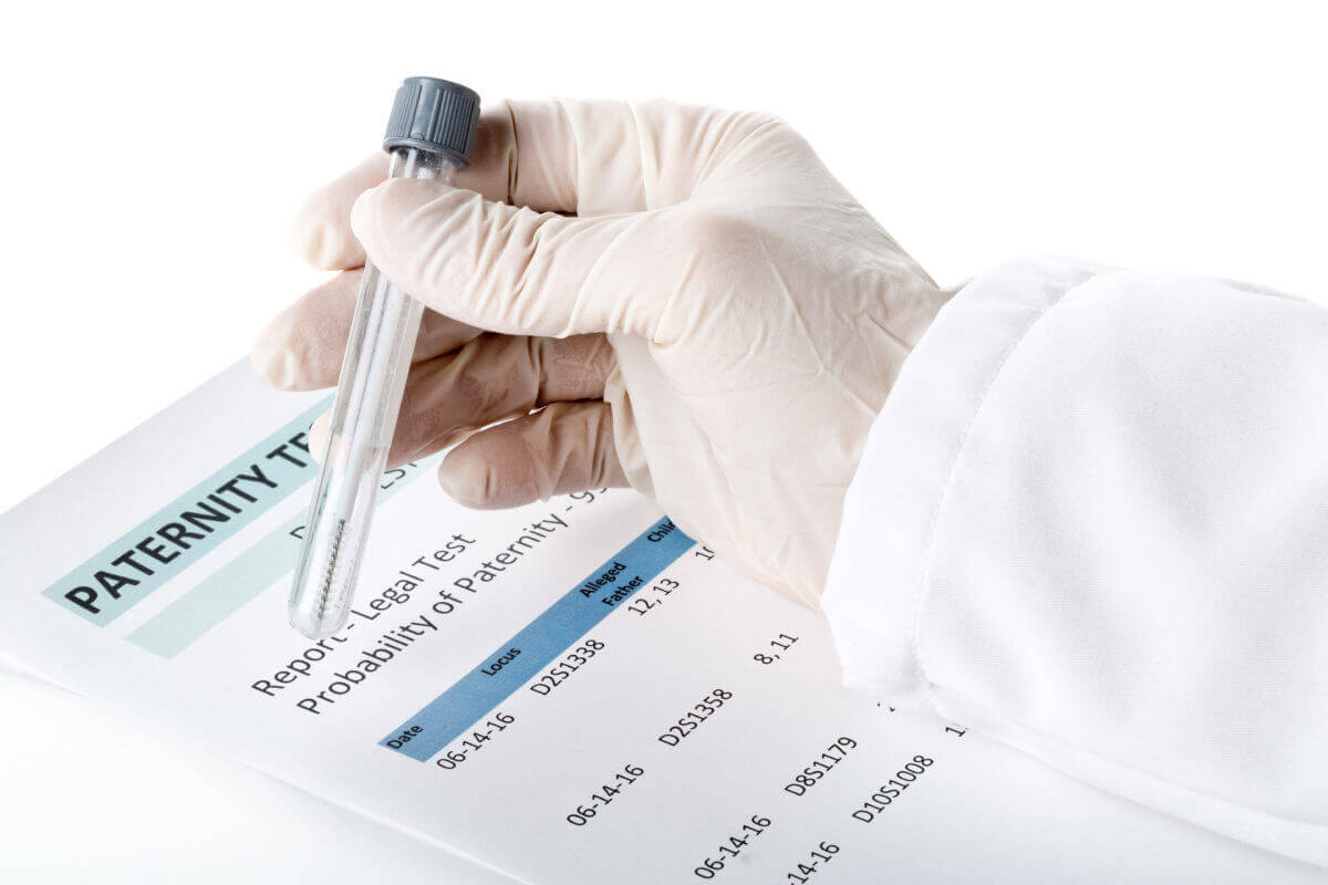 Lab technician holding a test tube performing a paternity test