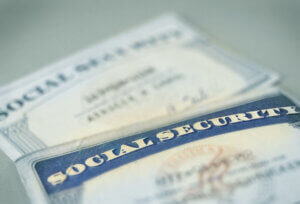 2 social security cards laying on a table