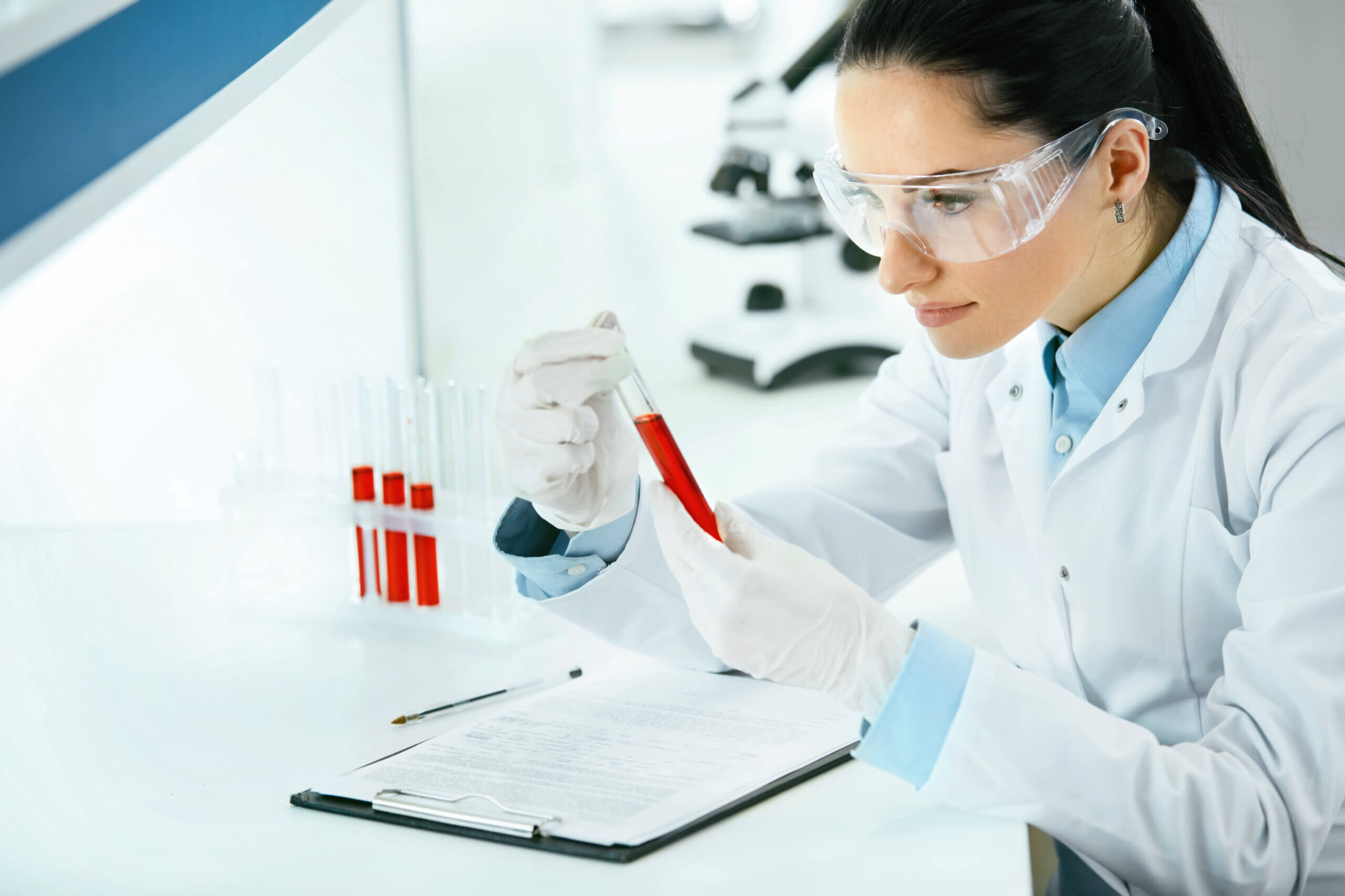 About Us Male medical professional preparing a patients collection cup for drug testing