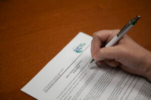 A patient signing an AZC drug testing form