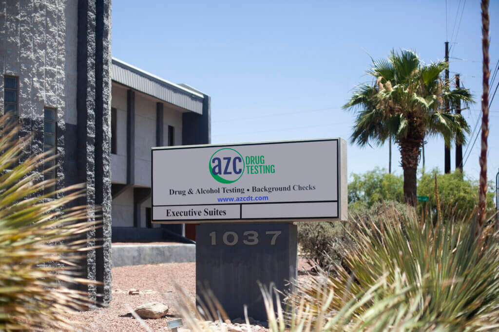 AZC Drug Testing sign in a garden of desert plants