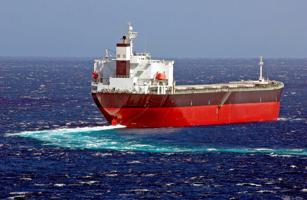 A cargo ship sailing on a white-capped ocean