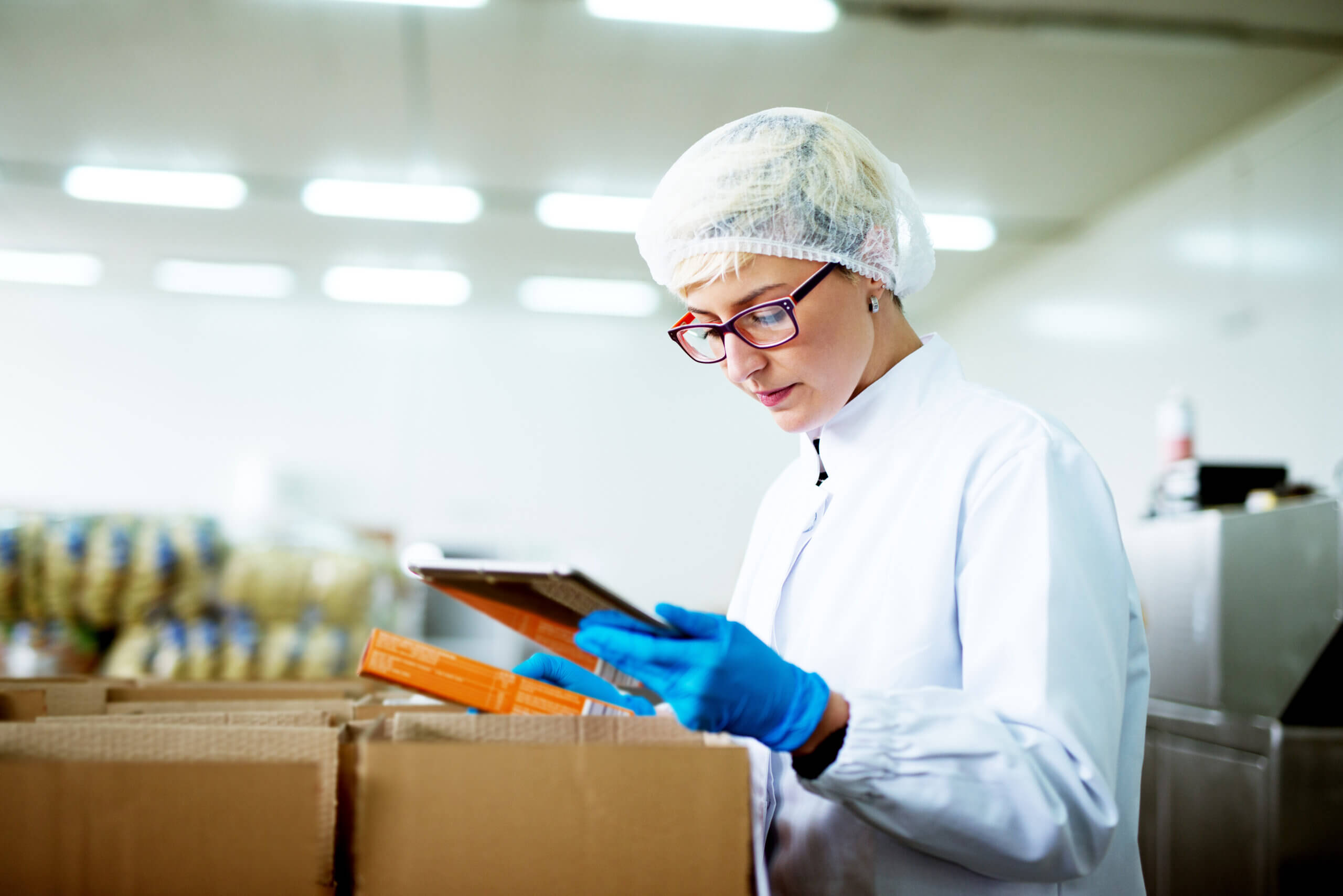 Lab worker unloading boxes of drug testing kits