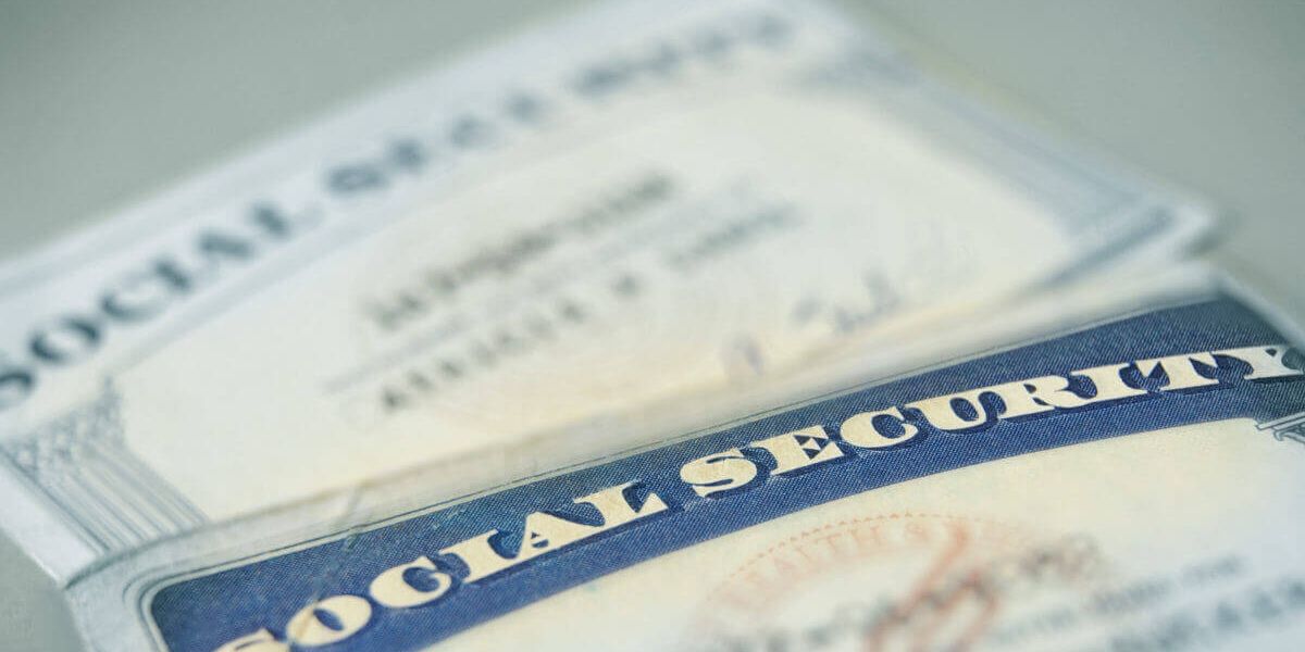 2 social security cards laying on a table