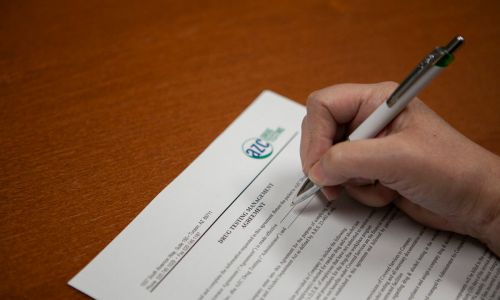 A patient signing an AZC drug testing form