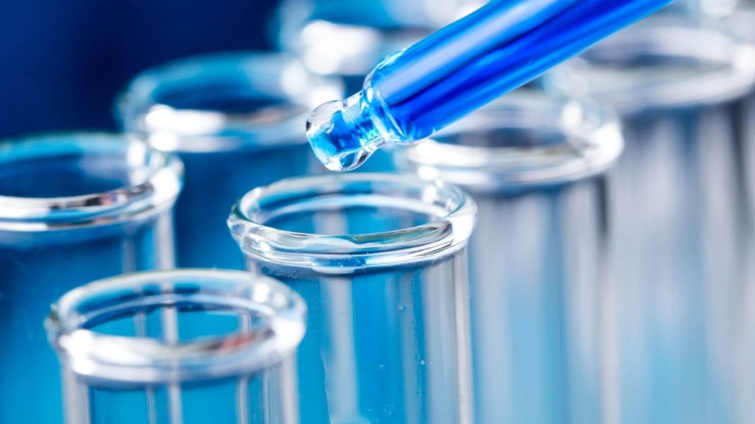 Background Screening Liquid being placed into a test tube for drug testing