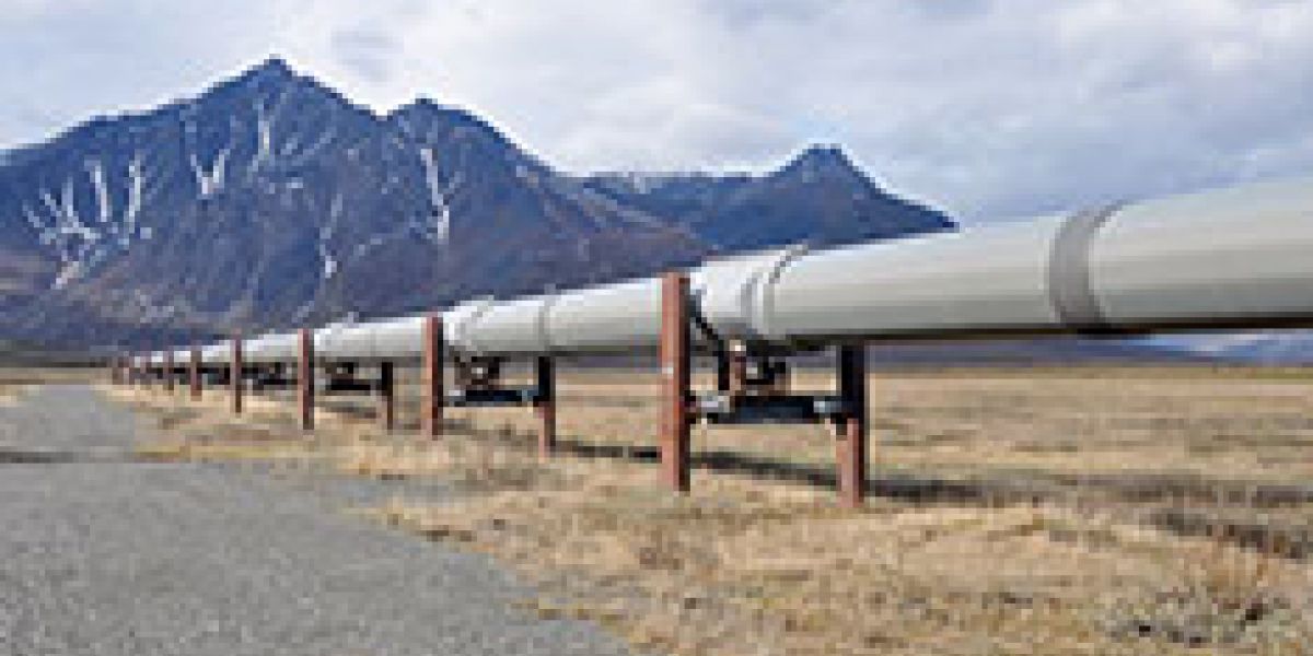 A pipeline going through the desert surrounded by mountains
