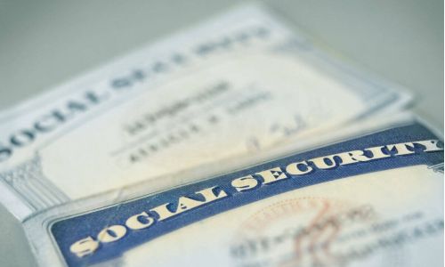 2 social security cards laying on a table