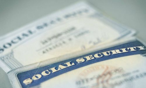 2 social security cards laying on a table